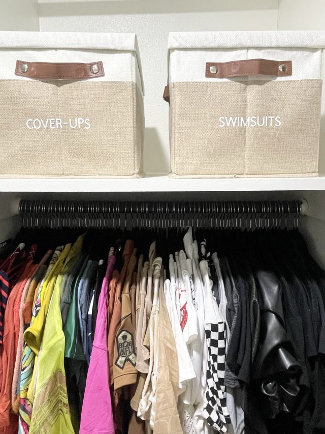 Fabric bins labeled cover-ups and swimsuits above a packed hanging rod
