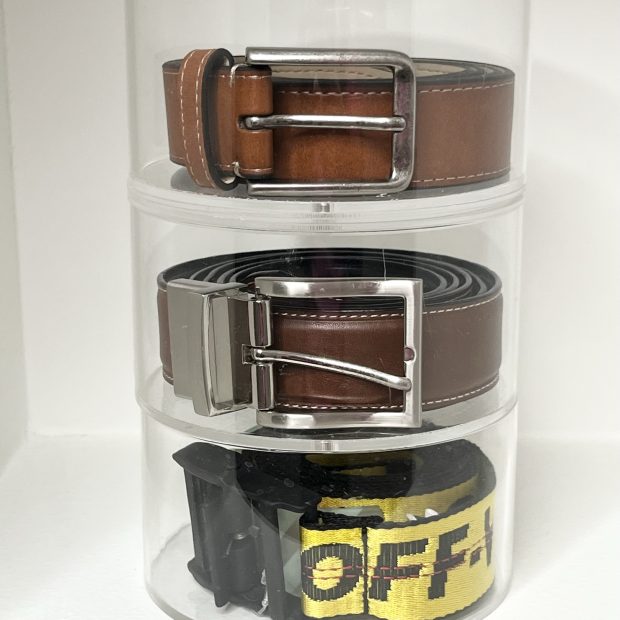 Leather belts coiled on a three-tier acrylic turntable