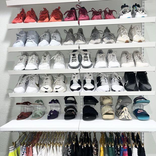 Six shelves of sneakers above a row of hanging activewear and printed leggings