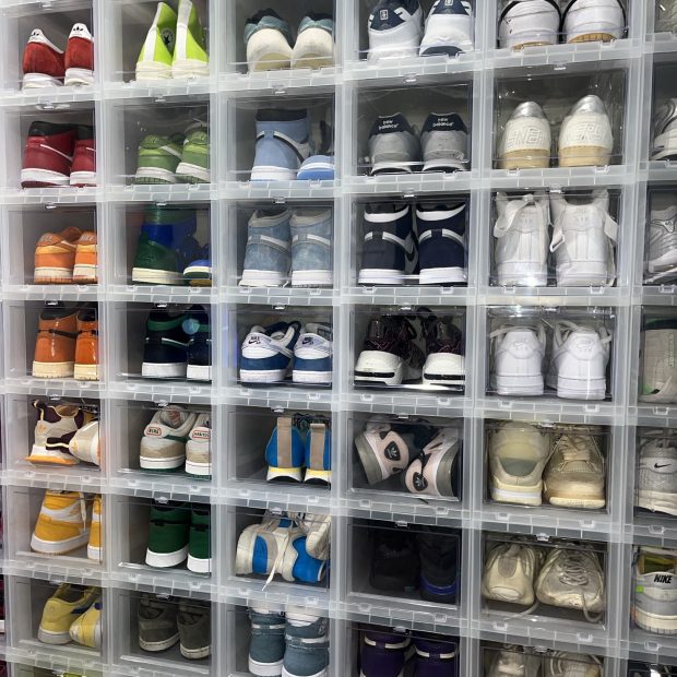 Clear shoe boxes filling a closet wall from floor to ceiling
