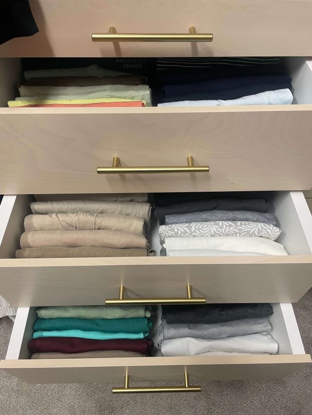 Closet drawer with precisely folded clothing separated into compartments