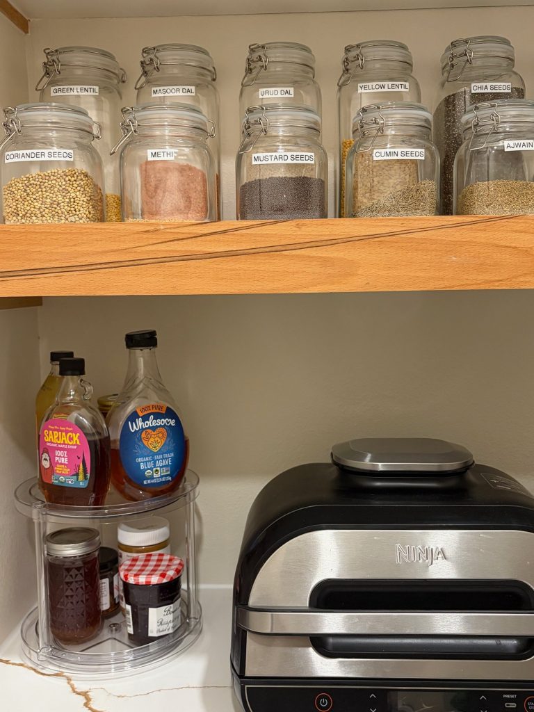 Spices decanted into uniform labeled glass jars