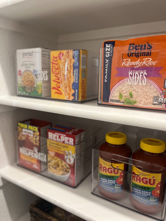 Pantry organized with labeled acrylic containers after a Plano relocation unpack