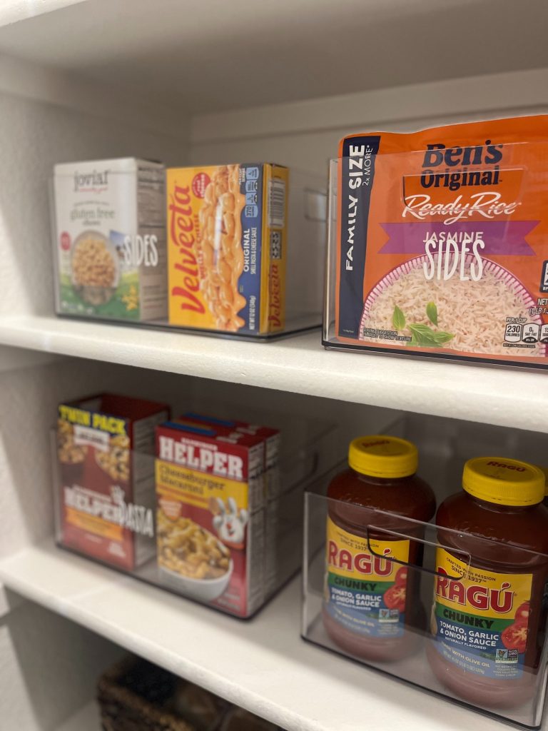 Pantry with labeled acrylic containers holding dry goods